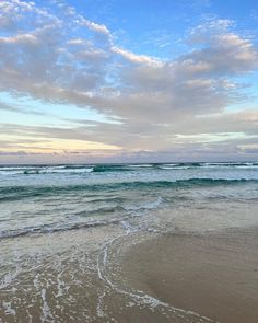 the ocean waves are rolling in to shore