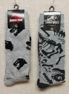 two pairs of socks with dinosaurs on them, one in grey and the other in black