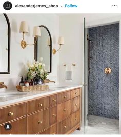 a bathroom with two sinks and mirrors in it