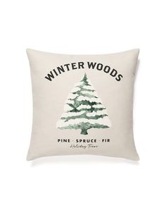 a white pillow with a pine tree on the front and winter woods printed on it