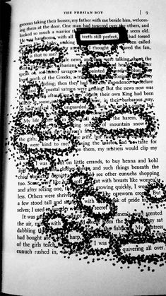 an open book with black ink sprinkles on it