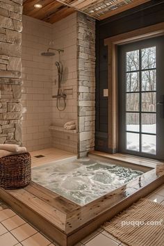 an indoor jacuzzi tub in the middle of a tiled floored room with large windows