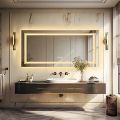 a modern bathroom with marble counter tops and gold faucets, along with a large mirror above the sink