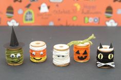 four spools of thread with halloween decorations on them