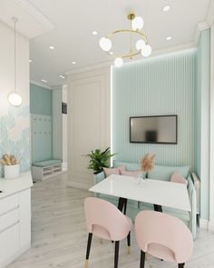 a dining room with pink chairs and a flat screen tv mounted on the wall above it