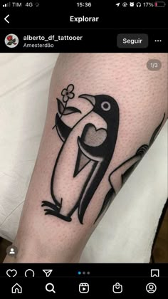 a black and white penguin tattoo on the left leg, with an arrow in its beak