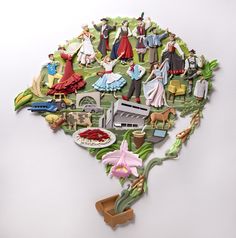 a paper cut out of the shape of a map with people and animals on it