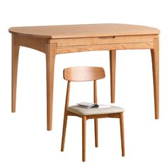 a wooden desk with a chair next to it and a book on the table top