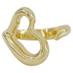 Tiffany & Co. 18K Yellow Gold Elsa Peretti Open Heart Ring is a charming and elegant piece of jewelry from the renowned luxury brand. Here's what you need to know about it: Material: Crafted from high-quality 18K yellow gold, this ring exudes warmth and richness, making it a timeless addition to any jewelry collection. Design: Designed by the legendary Elsa Peretti, this ring features an open heart motif, which is a signature design element of her collection with Tiffany & Co. The open heart sym Open Heart Ring, Heart Motif, Elsa Peretti, Collection Design, Tiffany And Co, Open Heart, Look Plus, Layered Look, Jewelry Rings Engagement