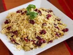 a white plate topped with rice and cranberries