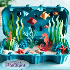 an ocean scene made out of foam with fish, seaweed and corals on the bottom