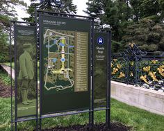 a sign in front of a fence with a map on it