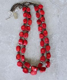 This eye-catching Necklace showcases 2 Strands of Bamboo Coral Oval Nuggets. The Nuggets are a lively coral-red with characteristic black markings, and have been cut with 2 flat sides and a flat round circumference. The structure is both uncommon and attractive. The Coral is slightly graduated — ranging from 11-by-14mm to 14-by-18mm. The stones have been polished to a glossy sheen. We've paired the Coral Nuggets with 17 6mm Oxidized Sterling Silver Rounds, adding subtle shine. The Sterling is co Red Oval Beads Jewelry For Gift, Unique Red Single Strand Jewelry, Coral Double Strand Jewelry As Gift, Red Coral Oval Bead Jewelry As Gift, Traditional Red Oval Jewelry, Coral Double Strand Jewelry For Gifts, Coral Double Strand Jewelry Gift, Artisan Red Jewelry With Gemstone Beads, Handmade Red Coral Jewelry With Oval Beads