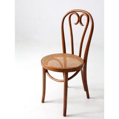 a wooden chair with wicker seat and backrests on a white background,