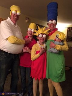 a group of people dressed in costumes posing for a photo with the simpsons characters on their heads