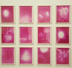 pink images are arranged on a white wall