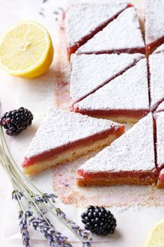 the dessert is cut into squares and served with blackberries, lemons, and lavender