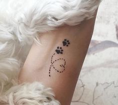 a dog paw tattoo on the ankle