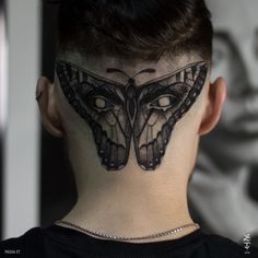 a woman with a butterfly tattoo on her neck and behind her head is a man's head