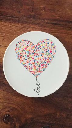 a plate with a heart shaped balloon on it