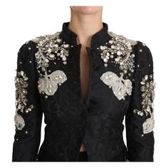 Embrace the epitome of Italian luxury with this exquisite Dolce & Gabbana black jacquard jacket, adorned with silver baroque detailing and a vibrant Sicilian floral motif. Each crystal and flower embellishment is meticulously hand-sewn, reflecting the brand’s commitment to outstanding craftsmanship. Perfect for sophisticated evening wear, this waist-long jacket coat features a sleek button closure and is lined with sumptuous black silk stretch fabric for ultimate comfort and elegance. Made in It Dolce Gabbana Jacket, Long Coat Jacket, Jacquard Jacket, Polyester Jacket, Floral Jacket, Jacquard Pattern, Blazer And Shorts, Dolce E Gabbana, Long Jacket