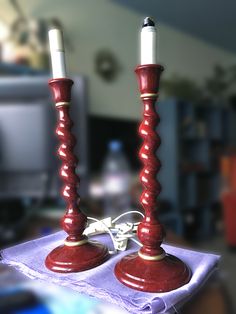 two red candles sitting on top of a table