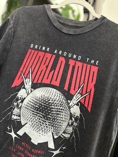 Drink Around The World - World Tour Vintage Black Tee! Featuring a vintage black rock tee design, this shirt showcases the iconic Epcot ball and highlights all the countries where you can indulge in delicious drinks. Get ready for a global adventure! Band Tour Tshirt Design, Tour Merch Design, Tour Tshirt Design, Tour Shirt Design, Epcot Ball, Svt Concert, Marathon Tee, Graphic Tees Street Style, Aesthetic Merch