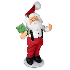 a santa clause figurine holding a book