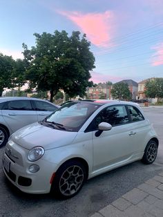 two cars parked in a parking lot next to each other