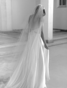 a woman in a wedding dress and veil