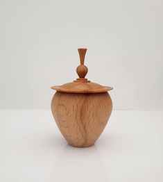 a small wooden jar with a lid