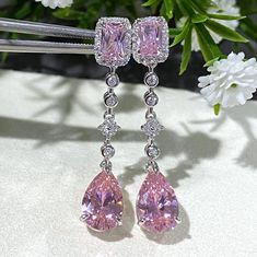 These exquisite vintage dangle earrings feature vibrant pink sapphires surrounded by sparkling white topaz stones, all set in sterling silver (marked 925). The combination of the colorful gemstones and shimmering silver gives these earrings a timeless, elegant appeal. Details: Total Weight: 4.8 grams Measurements: Height: 1 1/2" | Width: 2/8" Material: Sterling Silver (marked 925) Condition: Very good, with minimal signs of wear consistent with age. These earrings are perfect for special occasio Pink Diamond Earrings With Diamond Accents, Pink Earrings With Diamond Accents And Cubic Zirconia, Pink Diamond Accent Earrings For Formal Occasions, Formal Pink Earrings With Diamond Accents, Pink Diamond Teardrop Earrings, Pink Teardrop Diamond Earrings, Pink Teardrop Earrings With Prong Setting, Pink Sterling Silver Earrings With Diamond Accents, Sparkling Pink Cubic Zirconia Earrings