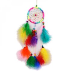 a multicolored dream catcher hanging on a white wall