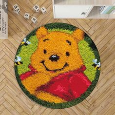 a winnie the pooh door mat is shown on a wooden floor with dices