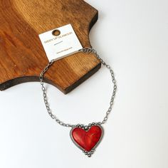 Silver Chain Necklace with Stone Heart Pendant in Red. Pictured on a white background with a piece of wood behind the necklace. Necklace With Stone, Red Studs, Giddy Up Glamour, Stone Heart, Silver Chain Necklace, Heart Pendant, Statement Pieces, Sale Items, Silver Chain