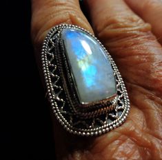 "Vintage Rainbow Moonstone Ring is a Large Best Quality Moonstone with Aqua, Indigo, and Gold Flashes Throughout, in a Bali Sterling Silver Ring, Size 7 It is bezel set in a solid sterling silver beautiful lacy pattern Bali style ring. Spectacular aqua, cobalt and indigo blue colors plus a beautiful gold streak in the middle flash brightly throughout the entire rainbow moonstone, and they seem to float throughout the almost clear freeform shaped gem. This is an especially beautiful clear and ver Fusion Style Moonstone Gemstone Ring For Anniversary, Fusion Style Anniversary Moonstone Gemstone Ring, Anniversary Fusion Style Moonstone Gemstone Ring, Anniversary Fusion Style Moonstone Ring, Silver Fusion Style Moonstone Gemstone Ring, Silver Fusion Style Moonstone Ring, Silver Moonstone Gemstone Ring, Fusion Style Oval Moonstone Ring, Fusion Style Oval Moonstone Ring Gift