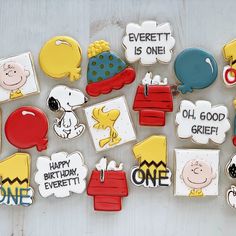 decorated cookies are arranged in the shape of charlie brown's birthday cake and other characters