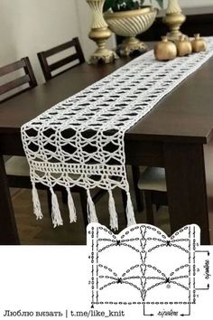 the table runner is crocheted with white yarn and has tassels on it