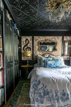 a bed in a room with a chandelier and bookshelves on the wall