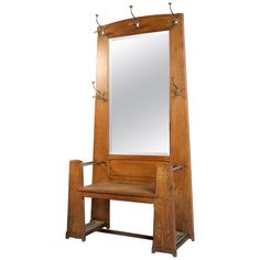 an antique wooden dressing table with mirror and bench on it's legs, isolated against a white background