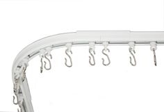 several hooks are hanging from the side of a white metal wall mounted shower curtain rod