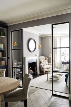 a living room filled with furniture and a fire place in the middle of a room