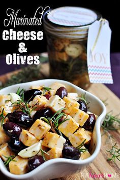 marinated cheese and olives in a white bowl