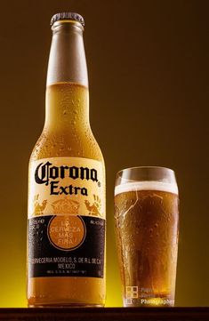 a beer bottle and glass sitting on a table