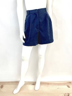 Vintage 90's Navy Blue, High Waisted, Shorts (M) These Ladies Shorts come in a navy blue cotton/polyester blend  and are high waisted with two front pockets, front pleat detail, two back pockets with belt loops, double button closure and adjustable flaps along the waistband, front metal zipper and single button closure. By Karen Scott. 65% Polyester 35% Cotton Made in Sri Lanka *Adjustable button waistband. *The shorts are in excellent condition with some light fading overall. Size (M) Modern Day 6/8 (Tag Size: 10) Waist: 26" or 27" (adjustable button) Hips: up to 40" Inseam: 4" Rise: 13" (Front) 15" (Back) Leg opening: 13 1/2" Weight 11 oz *Follow FreshandSwanky on Instagram Navy Cotton Shorts With Short Leg, Navy Relaxed Fit Bottoms, Short Length, Navy High Waist Cotton Pants, Blue High-waisted Bermuda Shorts With Pockets, Vintage Short Cotton Pants, Vintage Cotton Short Pants, Navy Bottoms With Pockets, Navy Cotton Bottoms With Built-in Shorts, High Waist Blue Cotton Shorts