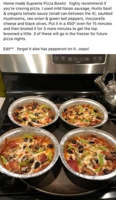 four pizzas sitting on top of an oven next to a pot and pan filled with food