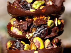 chocolate covered donuts stacked on top of each other with nuts and pistachio