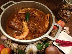 a large pot filled with food on top of a wooden table