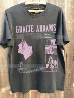 an old t - shirt that has been hung on a wooden fence with the words grace adams