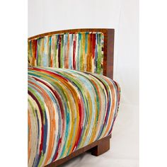 an upholstered bed with multicolored stripes on it